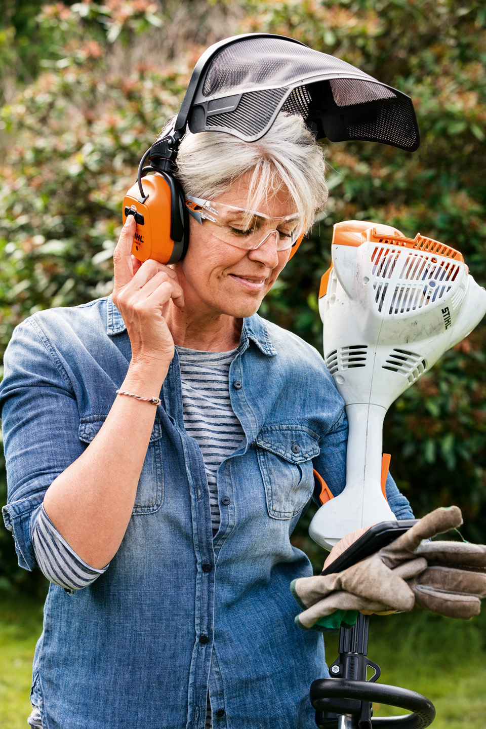 Frau mit Gesichts-/Gehörschutz und STIHL Motorsense FS 58 R